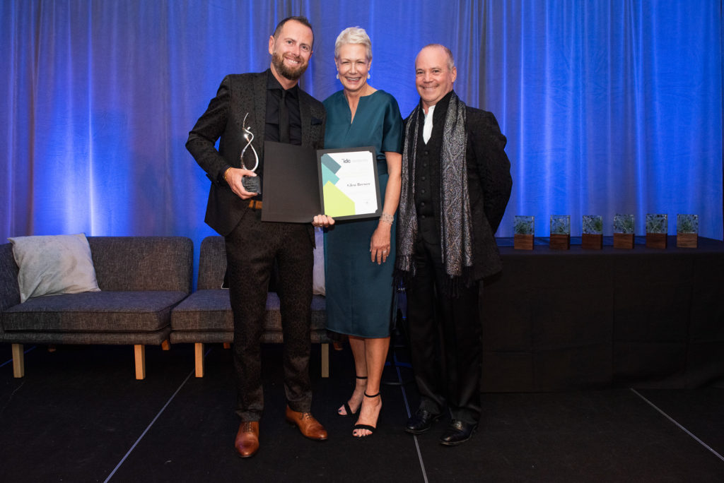 Glen Brewer (left) presented with 2019 IDC Legacy Award by Past President Sally Mills (center) and CEO Tony Brenders (right)